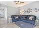 Living room with gray sectional sofa and tiled floor at 5613 N Laguna Ct, Litchfield Park, AZ 85340