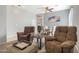 Cozy living room featuring comfortable armchairs and a view into the dining area at 5613 N Laguna Ct, Litchfield Park, AZ 85340