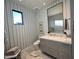 Elegant bathroom with a modern vanity and blue striped wallpaper at 6922 E Cactus Wren Rd, Paradise Valley, AZ 85253