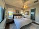 Spacious bedroom with king bed, ensuite bathroom, and wood floors at 6922 E Cactus Wren Rd, Paradise Valley, AZ 85253