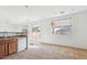 Kitchen with wooden cabinets, tile floor, and a view of the dining area at 7411 W Alta Vista Rd, Laveen, AZ 85339