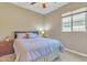 Cozy guest bedroom with a queen-size bed and nightstand at 789 E Blossom Rd, San Tan Valley, AZ 85143