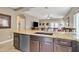 Kitchen island with sink and dishwasher, open to living area at 789 E Blossom Rd, San Tan Valley, AZ 85143