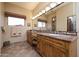 Double vanity bathroom with granite countertop and tiled shower at 8502 E Country Club Trl, Scottsdale, AZ 85255