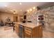 Large kitchen with granite island and stone fireplace at 8502 E Country Club Trl, Scottsdale, AZ 85255