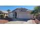 Single-story house with a two-car garage and desert landscaping at 9215 W Sandra Ter, Peoria, AZ 85382