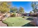 Landscaped backyard featuring a putting green and seating area at 937 N Kingston St, Gilbert, AZ 85233