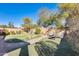 Landscaped backyard with putting green and fire pit at 937 N Kingston St, Gilbert, AZ 85233