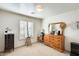 Well-lit bedroom with a dresser and mirror at 937 N Kingston St, Gilbert, AZ 85233