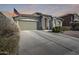 House exterior featuring a two car garage and desert landscaping at 937 N Kingston St, Gilbert, AZ 85233