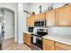 Kitchen area with wood cabinets and stainless steel range at 937 N Kingston St, Gilbert, AZ 85233