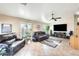 Spacious living room featuring tile floors and a large flat-screen TV at 937 N Kingston St, Gilbert, AZ 85233