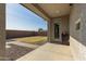 Covered patio, grassy area, and gravel landscaping in backyard at 9519 W Trumbull Rd, Tolleson, AZ 85353