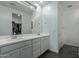 Modern bathroom with double vanity and walk-in shower at 9519 W Trumbull Rd, Tolleson, AZ 85353