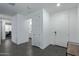 Bright entryway with grey tile flooring, coat closet, and bench at 9519 W Trumbull Rd, Tolleson, AZ 85353