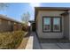 Side view of a house with a walkway and landscaping at 9519 W Trumbull Rd, Tolleson, AZ 85353