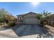 Single story home with a beige exterior and attached garage at 9519 W Trumbull Rd, Tolleson, AZ 85353