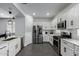 White kitchen with stainless steel appliances and ample counter space at 9519 W Trumbull Rd, Tolleson, AZ 85353