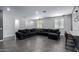 Open living space with grey sectional sofa and dark grey walls at 9519 W Trumbull Rd, Tolleson, AZ 85353