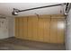 Garage with storage cabinets and door at 9714 W Edward Dr, Sun City, AZ 85351