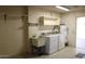 Laundry room with utility sink and cabinets at 9714 W Edward Dr, Sun City, AZ 85351