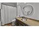 Cozy bathroom featuring a granite countertop, round mirror, and modern fixtures at 9837 E Pershing Ave, Scottsdale, AZ 85260