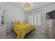 Bright bedroom with a decorative chandelier, plantation shutters, and a cozy, inviting atmosphere at 9837 E Pershing Ave, Scottsdale, AZ 85260