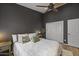 Cozy bedroom featuring a ceiling fan, closet, and natural light at 9837 E Pershing Ave, Scottsdale, AZ 85260