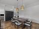 Dining space showcasing pendant lighting above a wooden table, neutral-colored decor, and an open flow to adjacent living areas at 9837 E Pershing Ave, Scottsdale, AZ 85260