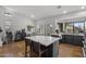 Well-lit kitchen featuring an island with seating, a bar area, and ample natural light at 9837 E Pershing Ave, Scottsdale, AZ 85260