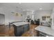 Expansive kitchen with a central island, dining area, fireplace, and additional seating space at 9837 E Pershing Ave, Scottsdale, AZ 85260