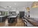 Spacious kitchen featuring stainless steel appliances, a large island, and an adjacent dining area with stylish lighting at 9837 E Pershing Ave, Scottsdale, AZ 85260