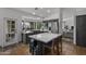 Bright kitchen showcasing stainless steel appliances, a central island, and a view into the living area at 9837 E Pershing Ave, Scottsdale, AZ 85260