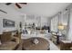 Spacious living area with light-colored walls, stylish furnishings, an area rug, and a view to another area at 9837 E Pershing Ave, Scottsdale, AZ 85260