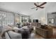 Cozy living space featuring plush sofas, shutters on the windows, a modern ceiling fan, and ample natural light for comfort at 9837 E Pershing Ave, Scottsdale, AZ 85260