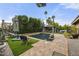 A stunning backyard pool area with lounge chairs, green turf, and mature landscaping for outdoor enjoyment at 9837 E Pershing Ave, Scottsdale, AZ 85260