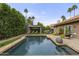 A private backyard pool area with mature landscaping, a gazebo, and outdoor lounge seating at 9837 E Pershing Ave, Scottsdale, AZ 85260