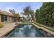 Beautiful backyard featuring a refreshing pool, lounge chairs, lush landscaping, and outdoor dining space at 9837 E Pershing Ave, Scottsdale, AZ 85260