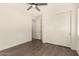 Bedroom with wood-look floors, double doors, and ceiling fan at 10012 E Tamery Ave, Mesa, AZ 85212