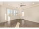 Bedroom with wood-look floors, ceiling fan, and door to patio at 10012 E Tamery Ave, Mesa, AZ 85212