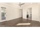 Bright bedroom with wood-look floors, ceiling fan, and door to patio at 10012 E Tamery Ave, Mesa, AZ 85212