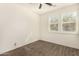 Bedroom with wood-look floors, ceiling fan, and window shutters at 10012 E Tamery Ave, Mesa, AZ 85212
