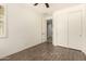 Bedroom with wood-look floors, ceiling fan, and double doors to closet at 10012 E Tamery Ave, Mesa, AZ 85212