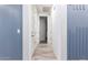 Clean hallway with wood-look floors and blue accent walls at 10012 E Tamery Ave, Mesa, AZ 85212