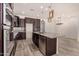 Modern kitchen with dark cabinets, granite countertops and island at 10012 E Tamery Ave, Mesa, AZ 85212