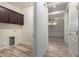 Laundry room with dark brown cabinets and wood-look floors at 10012 E Tamery Ave, Mesa, AZ 85212