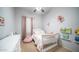 Charming bedroom with a crib and plenty of storage at 1022 E Hiddenview Dr, Phoenix, AZ 85048