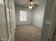 Carpeted bedroom offering a ceiling fan and a large window for natural light at 1022 E Hiddenview Dr, Phoenix, AZ 85048
