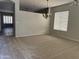 Bright, carpeted living room featuring large windows and a decorative chandelier at 1022 E Hiddenview Dr, Phoenix, AZ 85048