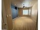 Spacious carpeted main bedroom featuring a ceiling fan, custom wall, and ensuite bathroom at 1022 E Hiddenview Dr, Phoenix, AZ 85048